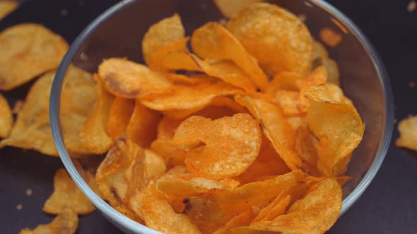 Crispy Fried Potato Chips on a Black Background