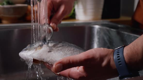 Cleaning Fish on Water Jet Before Cooking.