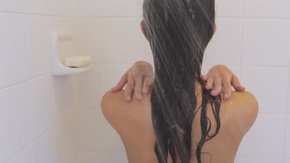 Attractive woman taking her morning shower.