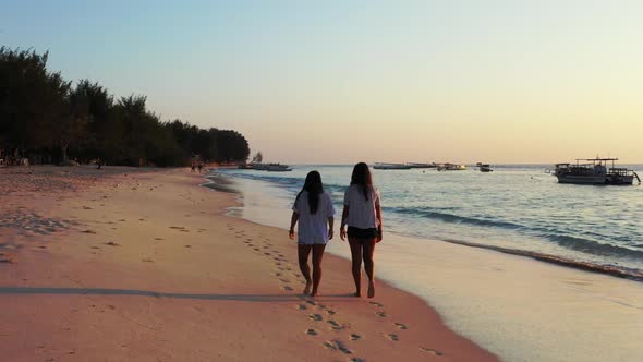 Women look beautiful on relaxing shore beach time by shallow lagoon and white sand background of Bal