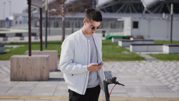 Young Man with a Phone in His Hands