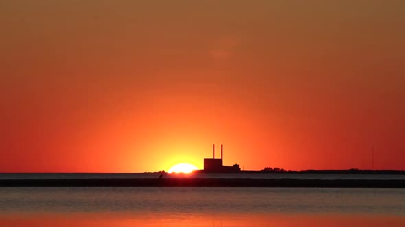 Sunset from beach in south Sweden. Power plant