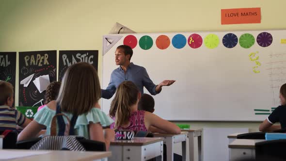 Male teacher teaching in the class