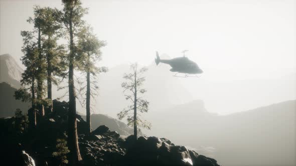 Extreme Slow Motion Flying Helicopter Near Mountain Forest