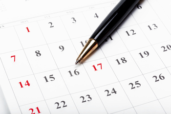 Check out the dates in a business calendar concept