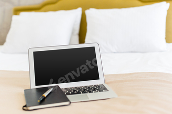 laptop on bed, notebook on bed