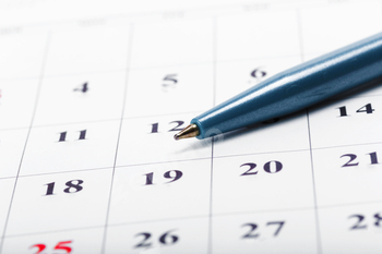 Check out the dates in a business calendar concept