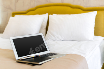 laptop on bed, notebook on bed