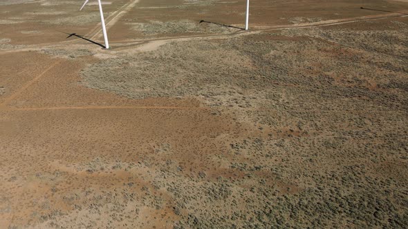 Desert Landscape Aerial With Wind Turbines Rotating Generating Clean Energy