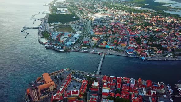 Tilt down aerial view of the districts of Punda and Otrobanda in the historic center of Willemstad,