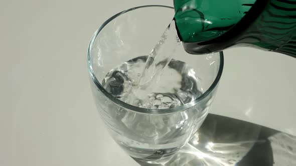 Drinking Water Poured Into a Clear Glass