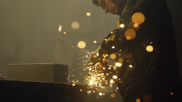 Industrial worker cutting metal