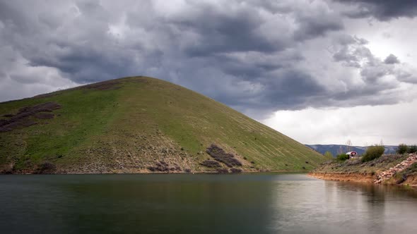 Time lapse of thick dark clouds moving Deer Creek Reservoir