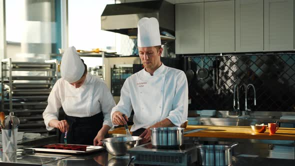 Milk is churned in a professional restaurant kitchen. Dessert cooking.