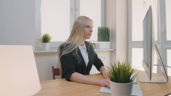 Upset Woman Sitting at Workplace. Blond Sad Female in Elegant Clothes Clutching Head After Failure