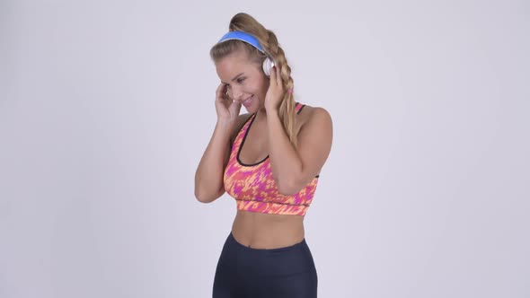 Happy Young Beautiful Blonde Woman Dancing and Listening To Music