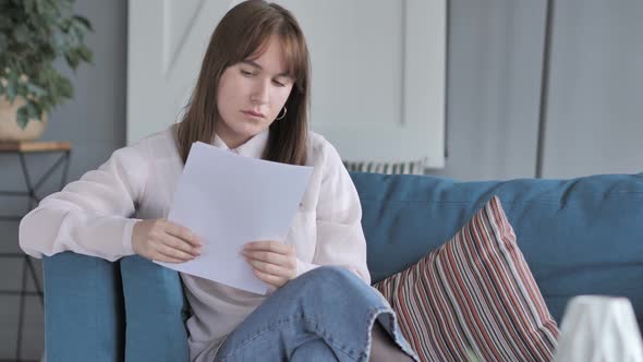 Young Woman Reading Papers