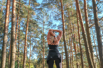 Fitness in the forest,Young woman doing fitness outdoors in the forest in summer, enjoying the fresh