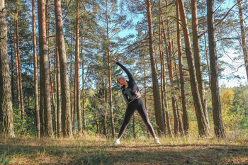 Fitness in the forest,Young woman doing fitness outdoors in the forest in summer, enjoying the fresh