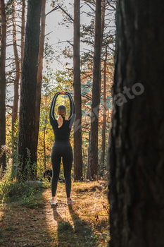 Fitness in the forest,Young woman doing fitness outdoors in the forest in summer, enjoying the fresh