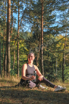 Fitness in the forest,Young woman doing fitness outdoors in the forest in summer, enjoying the fresh