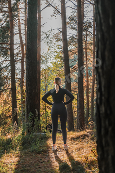 Fitness in the forest,Young woman doing fitness outdoors in the forest in summer, enjoying the fresh