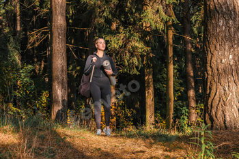 Fitness in the forest,Young woman doing fitness outdoors in the forest in summer, enjoying the fresh