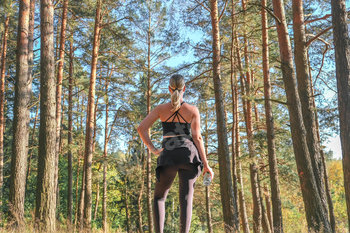 Fitness in the forest,Young woman doing fitness outdoors in the forest in summer, enjoying the fresh