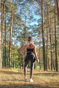 Fitness in the forest,Young woman doing fitness outdoors in the forest in summer, enjoying the fresh