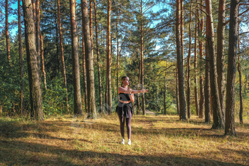 Fitness in the forest,Young woman doing fitness outdoors in the forest in summer, enjoying the fresh