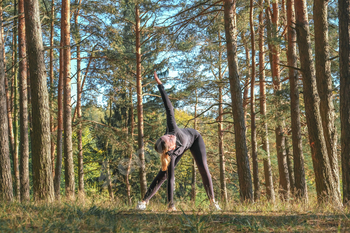 Fitness in the forest,Young woman doing fitness outdoors in the forest in summer, enjoying the fresh