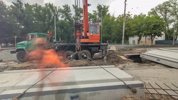 Installing Concrete Plates By Crane at Road Construction Site Timelapse Hyperlapse.