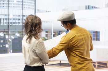 Realtor guiding businesswoman through a modern office space