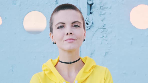  Portrait of Young Woman with Shaved Hair in Street Urban Background. 