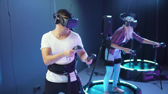Modern Interactive Technologies Man and Woman in Glasses of Virtual Reality Playing a Arcade Game