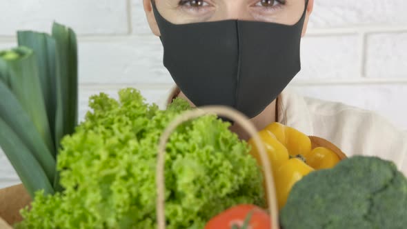 Woman in Mask Hold Vegetables