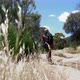 Woman with backpack on footpath in landscape, Victoria, Australia - VideoHive Item for Sale