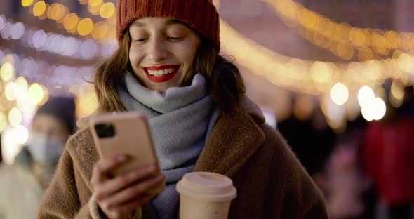 Woman Talking on Phone at Christmas Market