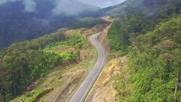 Camera Moves Over Empty Modern Winding Highway on Mountain