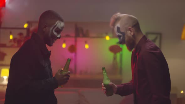 Men Chatting and Drinking Beer at Halloween Party