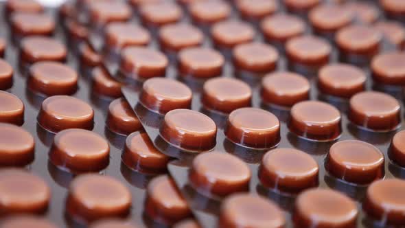 Rotating shot of brown colored packets on a white background