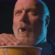 Focused senior man eating popcorn and watching a suspense movie at the cinema - VideoHive Item for Sale