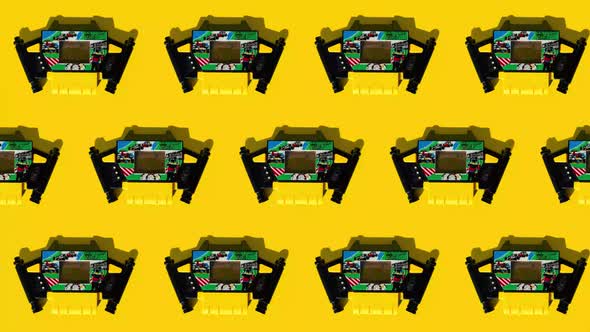 Row of moving game consoles on yellow background