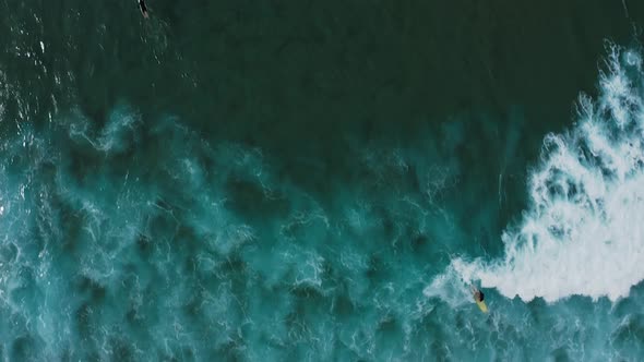 Aerial footage of surfers on the west coast of Portugal.