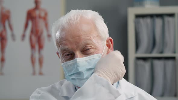 Portrait of Senior Experienced Physician in Protective Mask