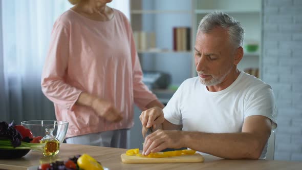 Disabled Husband Cooking Dinner in Kitchen, Caring Wife Hugging Him, Support