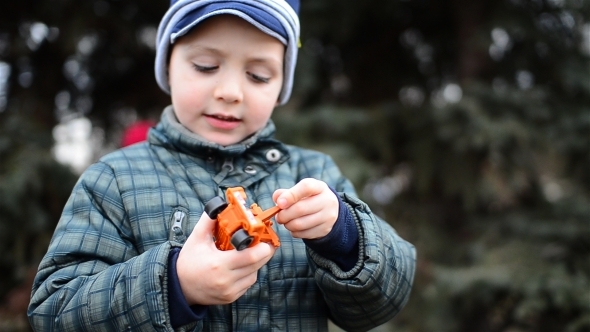 Boy Plays With Cars