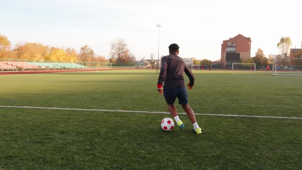 A Young Black Girl Training in the City Stadium and Show Dribbling with Soccer Ball and Steps on It