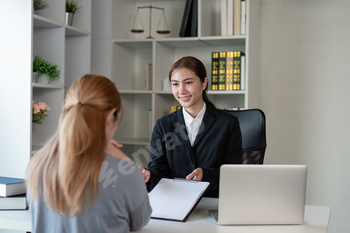 Asian Female Attorney Discussing Case with Client