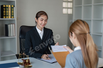 Asian Female Lawyer Handing Contract to Client